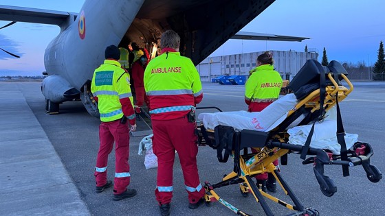 Image of an aircraft with ambulance personell outside
